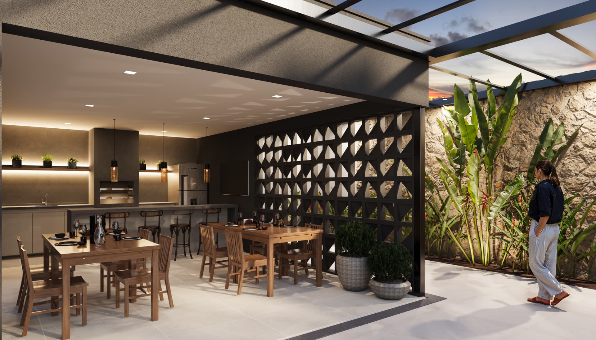 Espaço gourmet com churrasqueira do Sky Breeze, mesas de madeira, cobogó e jardim tropical